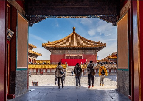 Visitors are entering the Forbidden City for a tour.