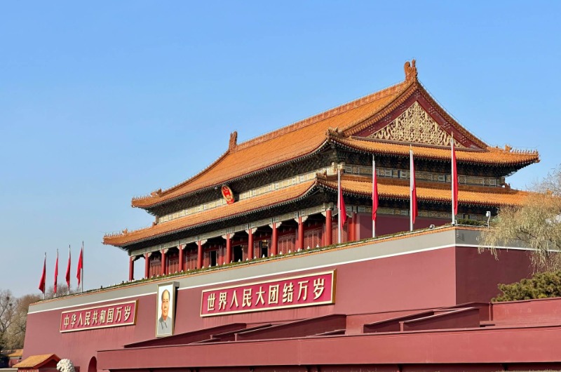 The Tiananmen Gate features the slogan Long Live the Unity of the People of the World.