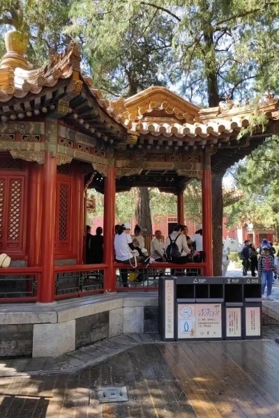 Tourists resting in the Imperial Garden of the Forbidden City.