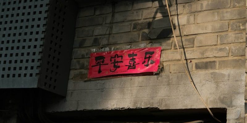 A red paper is posted on the wall, with "Peace and Joy" written on it.