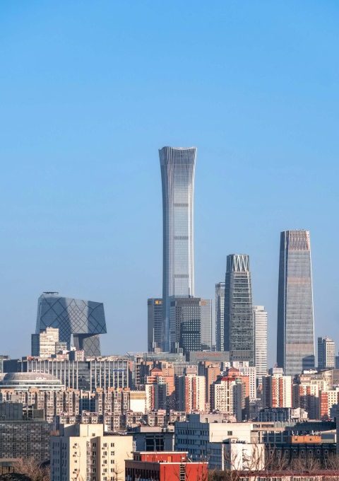 Beijing's skyline features many modern buildings with glass exteriors.