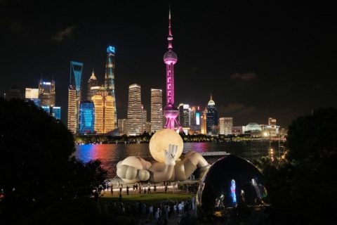 A giant doll sculpture has been placed along the Bund in Shanghai.