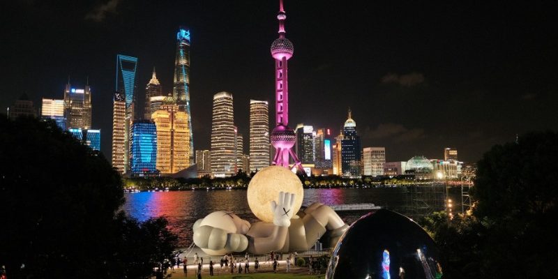 A giant doll sculpture has been placed along the Bund in Shanghai.