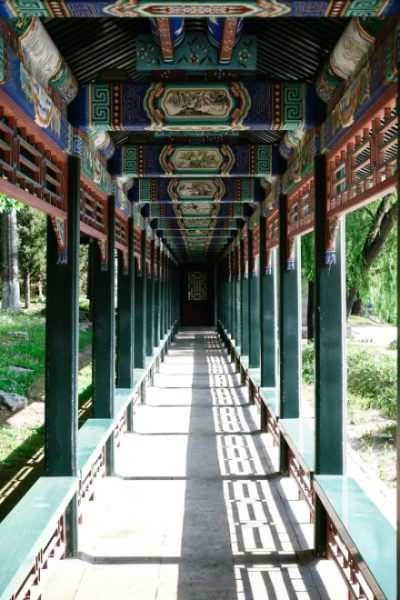 The long corridor is decorated with paintings of landscapes, flowers, birds, and scenes from the four classic Chinese novels