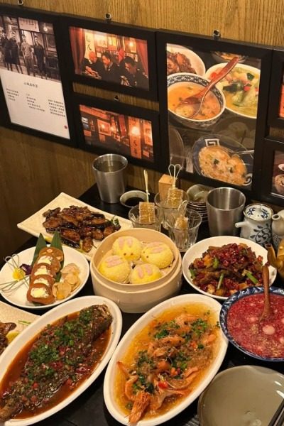 The table is filled with a variety of local Shanghai dishes.