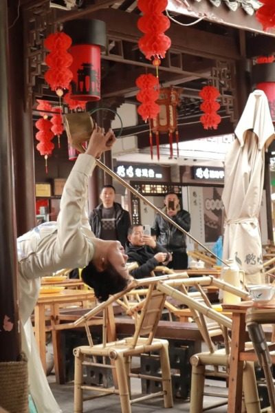 The staff at Heming Teahouse in Chengdu People's Park are performing tea art.