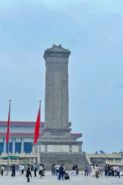 Tourists are admiring the Monument to the People's Heroes.