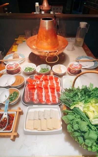 A table full of hearty, authentic Beijing dishes at Jubaoyuan Restaurant in Beijing.