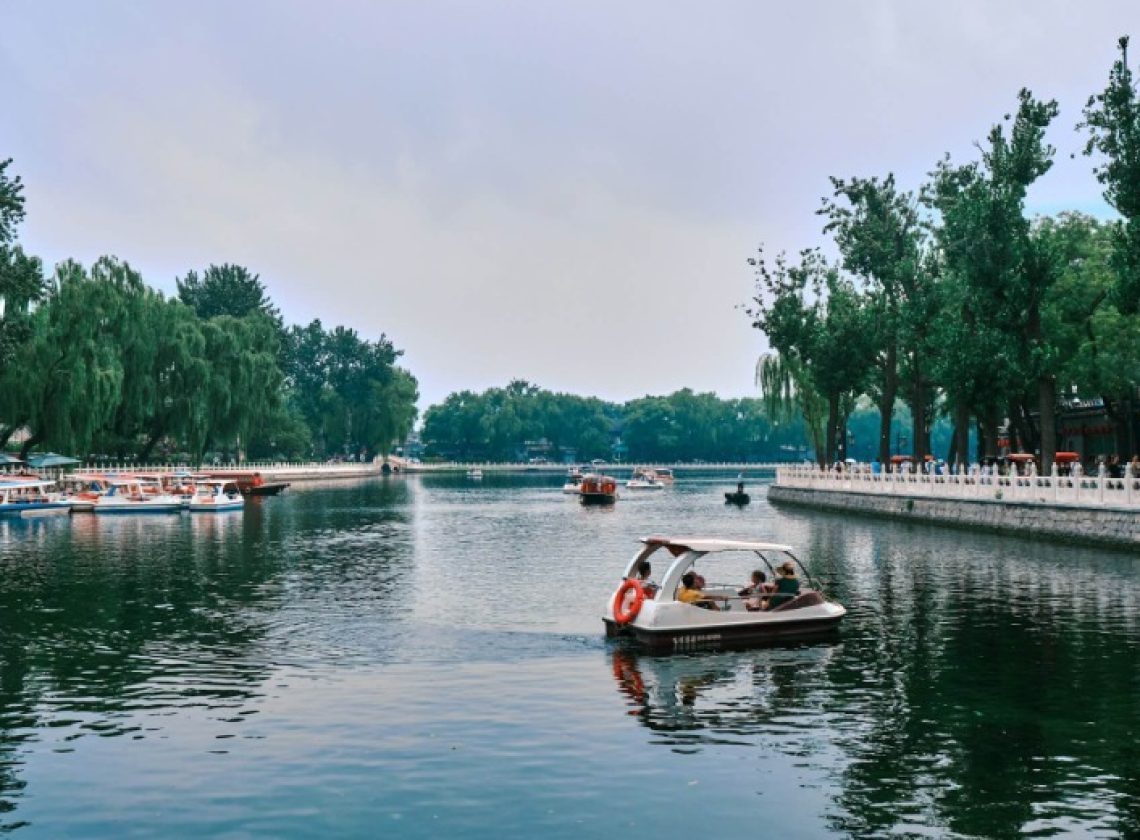 The lake at Shichahai has many visitors rowing boats.