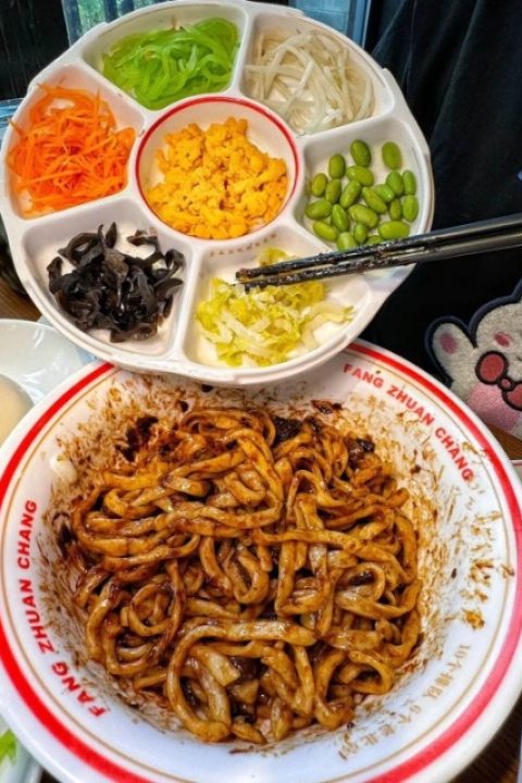 noodles with soy bean paste is served with a wide variety of side dishes