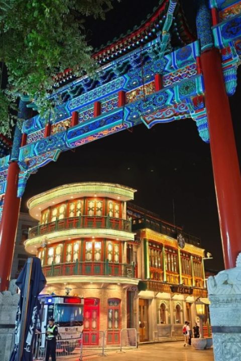 At night, the buildings behind Wupailou on Qianmen Street are all lit up.