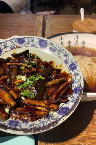 A-Niang Noodle Shop serves authentic local yellow fish noodles that are a must-try in Shanghai.