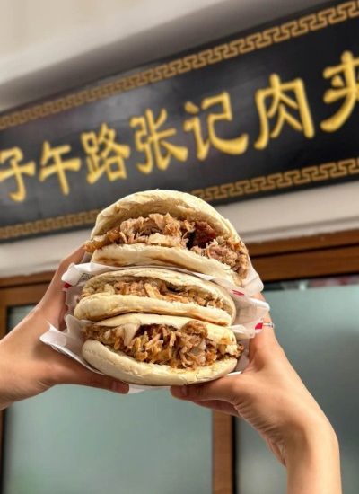 Roujiamo, often referred to as "Chinese hamburger," is a must-try dish in Xi'an, featuring tender meat stuffed in a freshly baked flatbread.