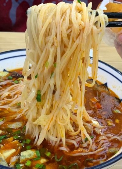 Saazi noodles are a beloved specialty in Xi'an, known for their hearty toppings and vibrant colors, creating a deliciously satisfying dish.