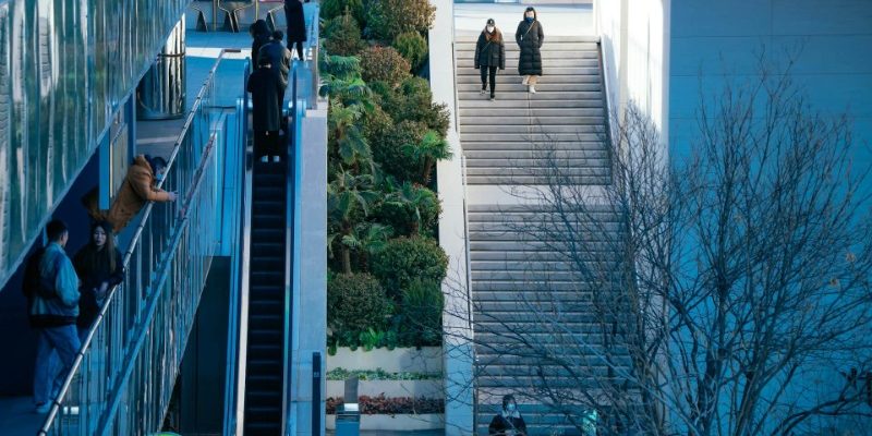 Tourists are walking down the stairs.