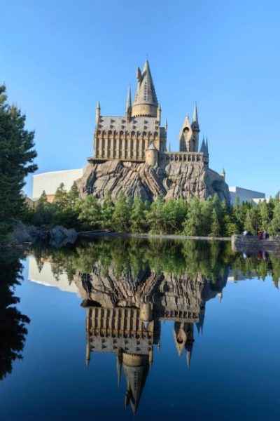 The Harry Potter Wizarding World castle features upper towers and a massive mountain base.