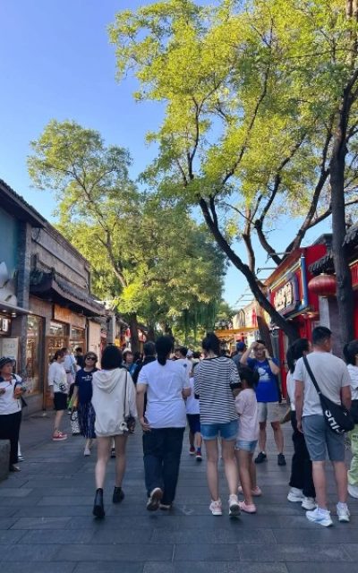 The bustling crowds of tourists are happily strolling through Nanluoguxiang.