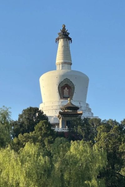 The White Pagoda in Beihai Park resembles a white bottle, surrounded by lush trees.