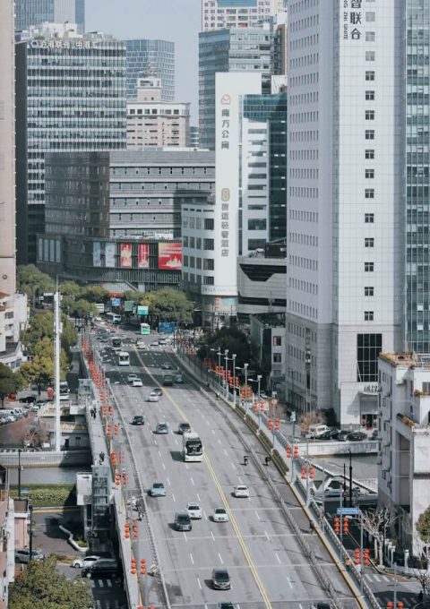 The roads in Shanghai are wide, and there are lots of cars on them.