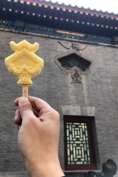 Visitors are holding ice cream shaped like the iconic windows of Prince Gong's Mansion.