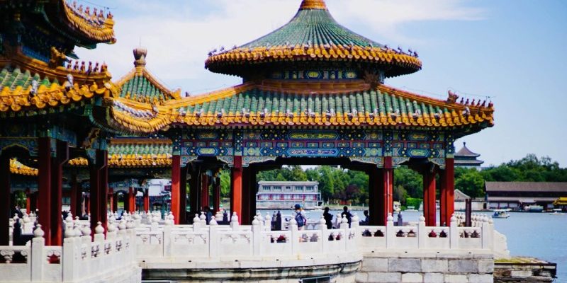 Visitors are admiring the lake view of Beihai Park from the Five-Dragon Pavilion.